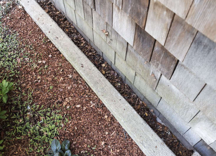 An unobtrusive perimeter drain runs alongside the foundation of a house in Mill Valley, California.