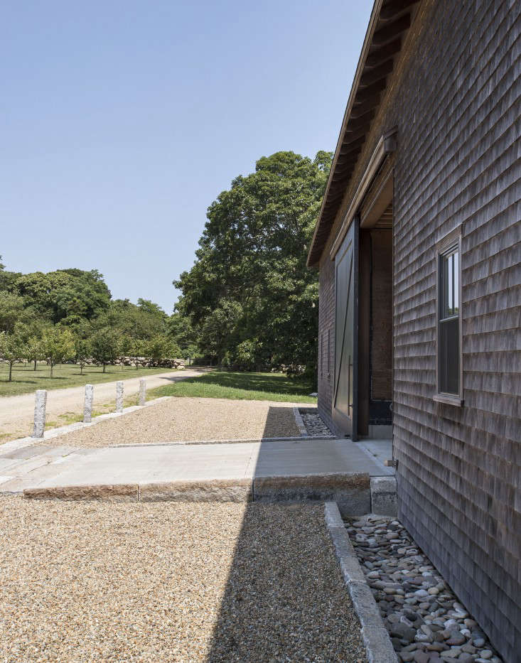 A French drain is installed around the perimeter of a barn on Martha